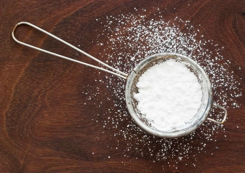 Sifted corn syrup solids on wood surface