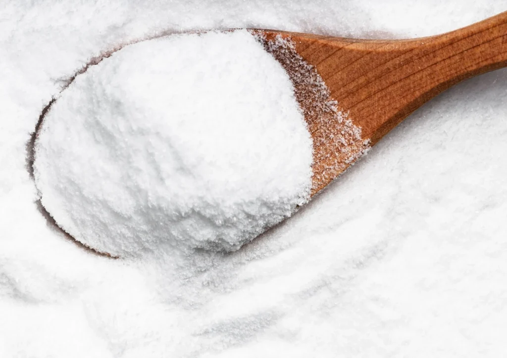 Spoon scooping fine dextrose powder