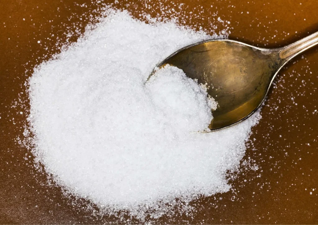 Spoon scooping fine crystalline fructose